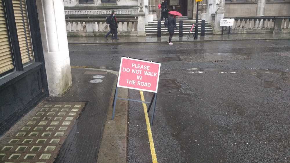 Please do not walk in the road
